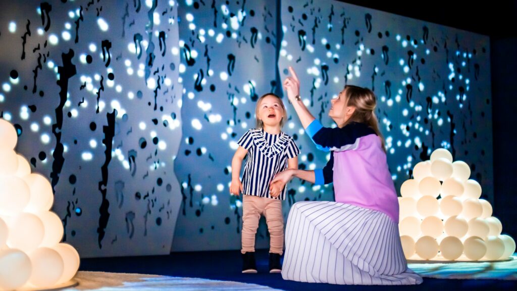 A woman and a small child marveling at the Moomin Museum.